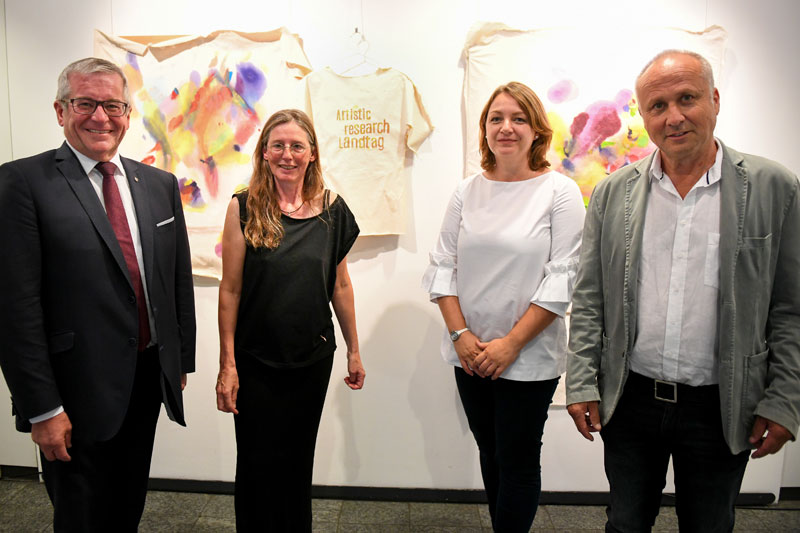 Kirsten Kötter: Artistic research Landtag. In: Bewegte Zeiten, exhibition, Landtag Rheinland-Pfalz,
  Abgeordnetenhaus Mainz, Germany, 04.09.2019 - 10.10.2019, exhibition opening, left to right: Hans-Josef Bracht
  (vice president of the Landtag), Kirsten Kötter (artist), Dr. Ana Karaminova (art historian),
  Dr. Paul Hirsch (artist). Photograph: Landtag Rheinland-Pfalz</span> / Andreas Linsenmann